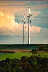 Wind turbines in a countryside landscape generate renewable energy, contributing to climate change...