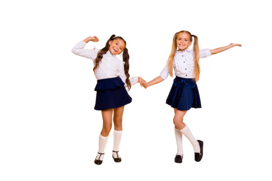 Back to school concept. Full length, legs, body, size portrait of  small girls happily jump holding hands isolated on bright yellow background