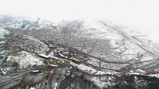 High-aerial shot of the Larung Gar Buddhist Academy and community in winter, Tibet, China