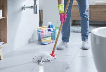 Woman cleaning up the floor with a mop