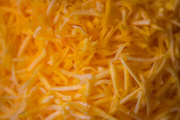 Grated fresh raw pumpkin prepared for cooking. Healthy vegetarian food ingredient.