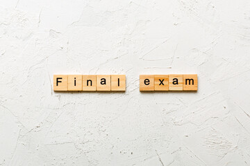 final exam word written on wood block. final exam text on table, concept