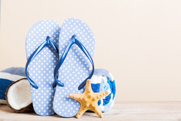 Top view composition of flip flops placed with beach accessories perspective view on table background. Tropical summer vacation concept Flat lay