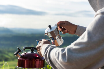 Naklejka premium Making drip coffee with a beautiful mountain and nature view in background
