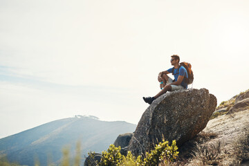 Man, outdoor and relax with backpack on rock with thoughts, thinking and serenity on adventure for...