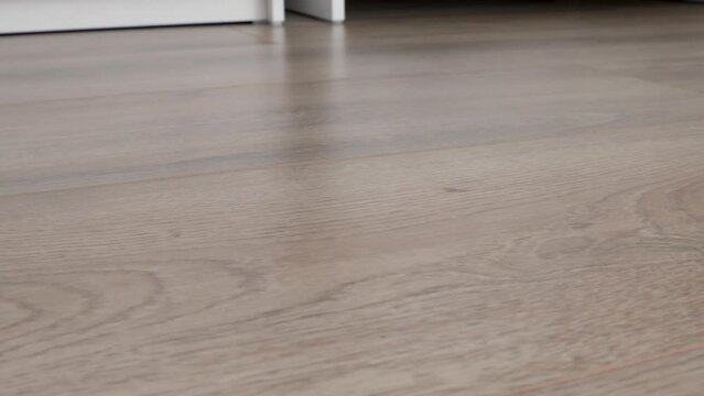 New laminate flooring. Laminated parquet with brown wooden texture