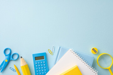 Colorful school supplies including pencils, scissors, notebooks, and a calculator arranged on a light blue background
