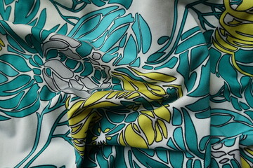 Rippled blue green, white, yellow and grey polyester fabric