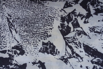 Close shot of white and dark blue fabric with abstract print