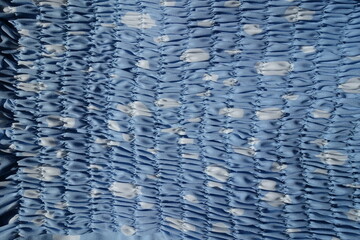 Top view of  light blue and white rayon fabric with shirring