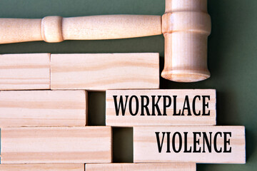 WORKPLACE VIOLENCE - words on wooden blocks on a white background with a judge's gavel.