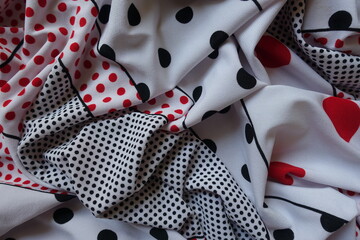 Folded white, red and black spotted rayon fabric