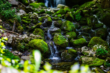 Waterfall flows through stones in nature