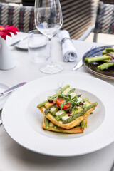 Roasted asparagus with cheese on a toast bread