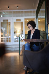 A woman looking the mobile phone in the hotel lobby.