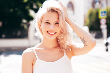 Closeup portrait of young beautiful smiling woman. Sexy carefree model posing on the street...