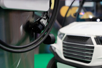 Close-up of a electric charging station on the background of electric car.