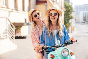 Two young beautiful smiling hipster female in trendy clothes. Carefree women driving retro...