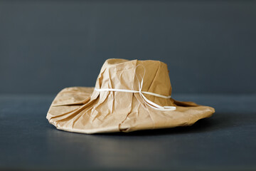 A brand new hat wrapped in rustic beige craft paper. Black Friday shopping concept.