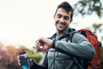 Happy man, water and watch in nature for trekking, backpacking and sunset on journey. Male hiker,...
