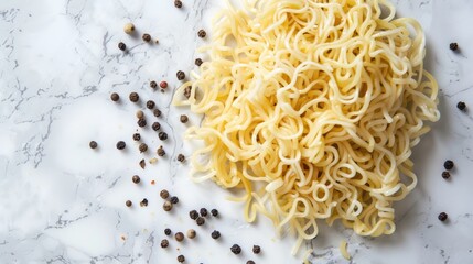Noodles and peppercorns on a marble surface