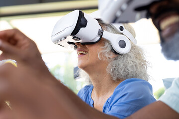 At home, diverse senior friends exploring virtual reality