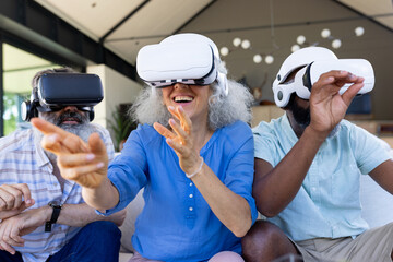 At home, diverse senior friends enjoying virtual reality together