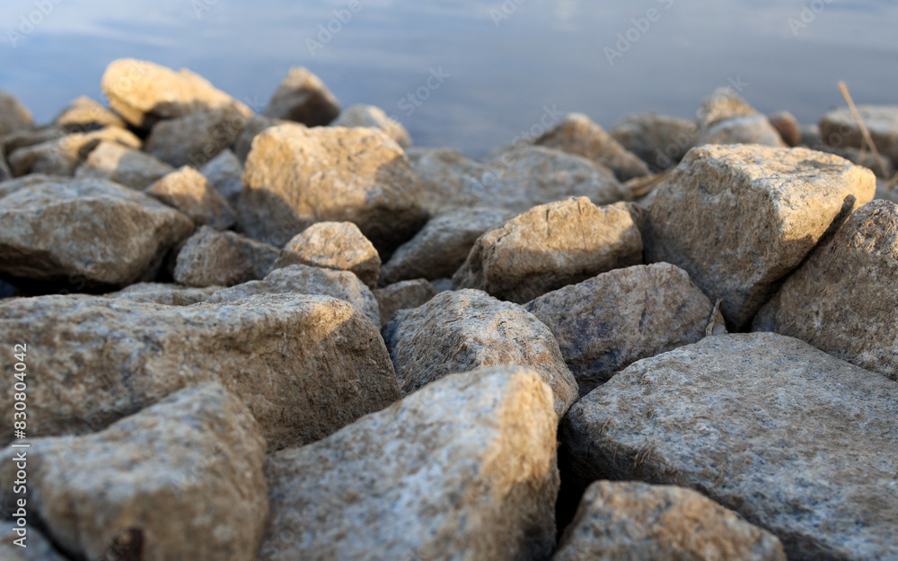 Wall mural pebbles on the sea, illuminated by the sun. close-up