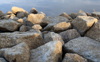 Pebbles on the sea, illuminated by the sun. Close-up