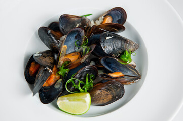 Fresh steamed mussels with lime and herbs © AntAlexStudio