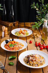 Gourmet italian pasta dishes on rustic wooden table