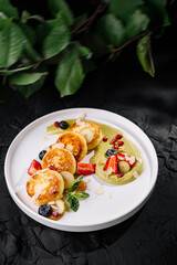 Gourmet cheese pancakes with fresh berries and sauce