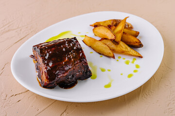 Glazed pork ribs with roasted potato wedges