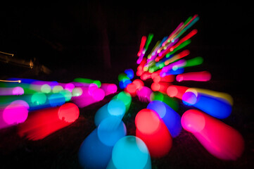Light painting abstract background. Colorful light balls, long exposure. Abstract butterfly against a black background. Zoom burst effect.