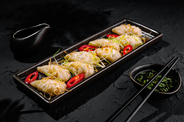 Exquisite asian dumplings with dipping sauce