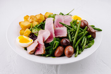 Fresh tuna nicoise salad on white background
