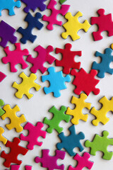 Colorful jigsaw puzzle pieces on white background. Flat lay.