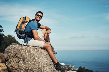 Man, forest and happy with backpack on rock with view for calm, relax and serenity on adventure for...