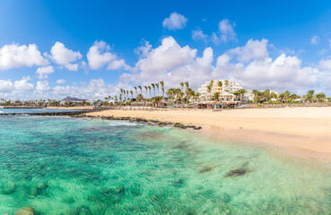 Playa de las Cucharas, Costa Teguise, Lanzarote: A perfect family beach with golden sand, turquoise waters, and a variety of water sports.