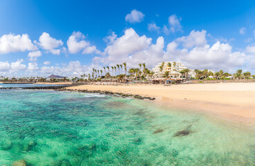 Playa de las Cucharas, Costa Teguise, Lanzarote: A perfect family beach with golden sand, turquoise waters, and a variety of water sports. © Balate Dorin