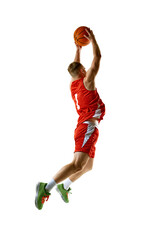 Basketball player, dressed in red uniform, performing perfect slam dunk against white studio...