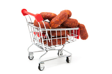 Shopping supermarket cart with dry-cured sausages isolated on a white background. Purchase of...