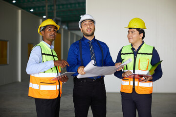 workers or engineers planning from work on blueprint drawing paper in the factory