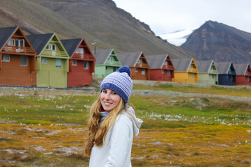 Young tourist woman in Longyearbyen, Svalbard. Summer time adventure travel in Norwegian Arctic.