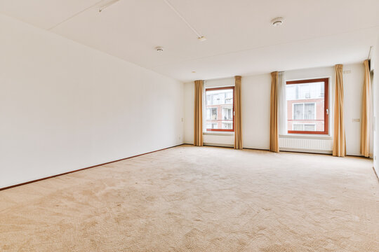 Spacious empty room with large windows in Amsterdam