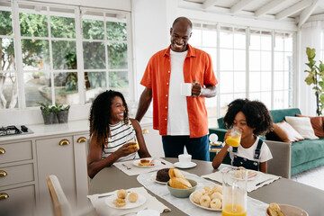 Happy family enjoying breakfast together in a sunny kitchen