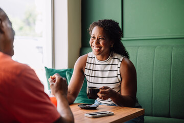 Black woman smiling and having fun in a cafe