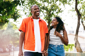 Happy black couple smiling and having fun on a sunny day