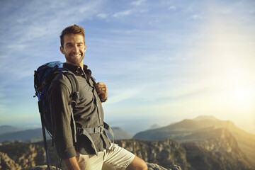 Portrait, mountains and hiking with man, fitness and journey with nature, sunshine and adventure. Hobby, person and hiker with backpack, health and environment with happiness, holiday or getaway trip