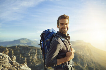 Portrait, mountains and hiking with man, nature and journey with wellness, sunshine or getaway trip. Walking, person and hiker with backpack, adventure or environment with happiness, holiday or smile